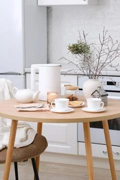 Home spring easter interior in kitchen. Beige chair with white cover, white Stock Photos