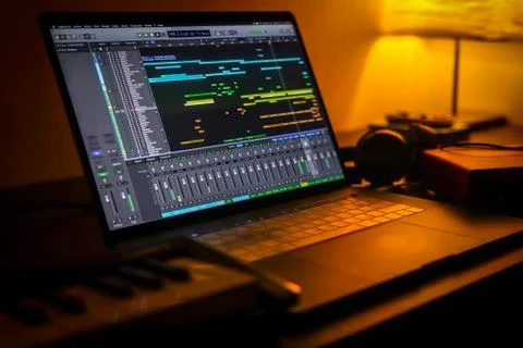 Home Studio Music Production Workspace with MacBook Pro and Keyboard Stock Photos