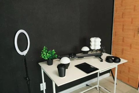 Home studio setup with ring light, tablet, and coffee for content creation Stock Photos