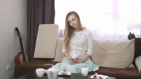 Home, technology and internet concept - smiling woman sitting on the couch with Stock Footage 74626148