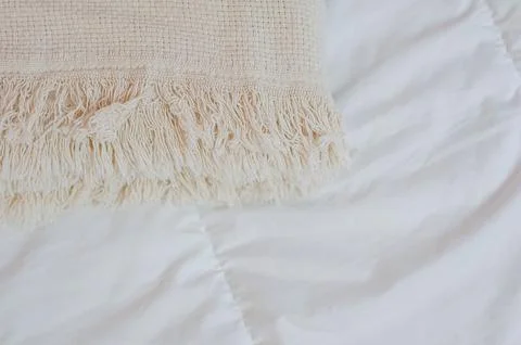 Home textiles. A stack of towels lies on a white bed Stock Photos