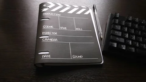 At home, there is a notebook on the table that resembles a movie clapperboard Stock Footage 160555921