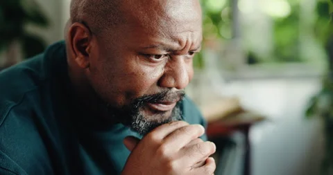 Home, thinking and black man concerned with reflection, retirement and sad with Stock Footage 323307405