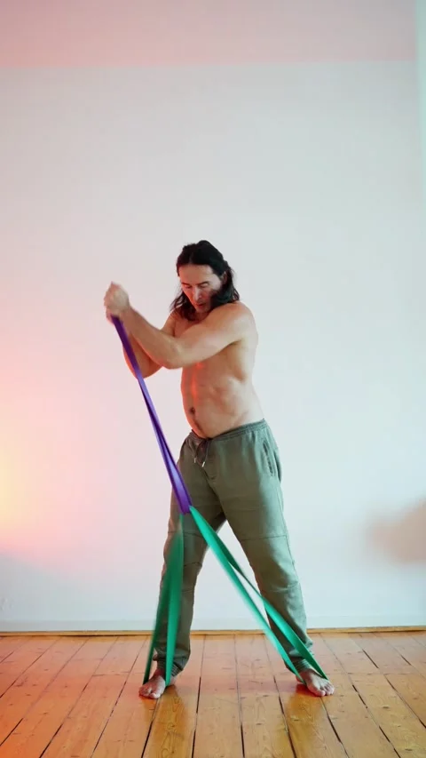 Home training concept where likable concentred sporty man in sportswear doing Stock Footage 302654855