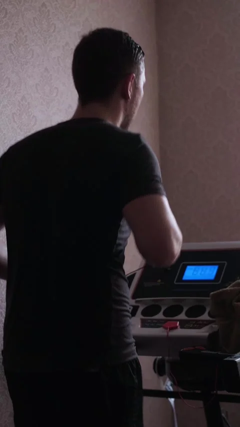 Home treadmill workout is a comfortable and effective way to stay fit and active Stock Footage 305570949