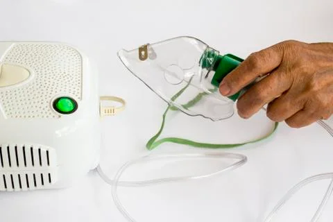 Home type mini air machine with oxygen mask in hand Stock Photos