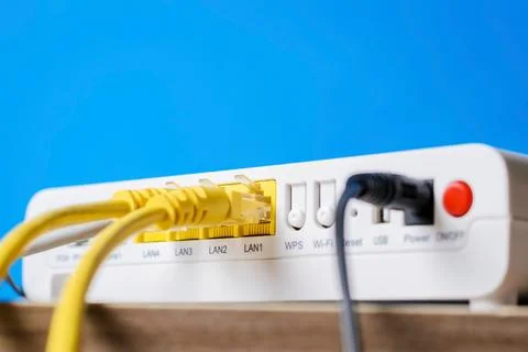 Home wireless router with ethernet cables plugged in, closeup Stock Photos