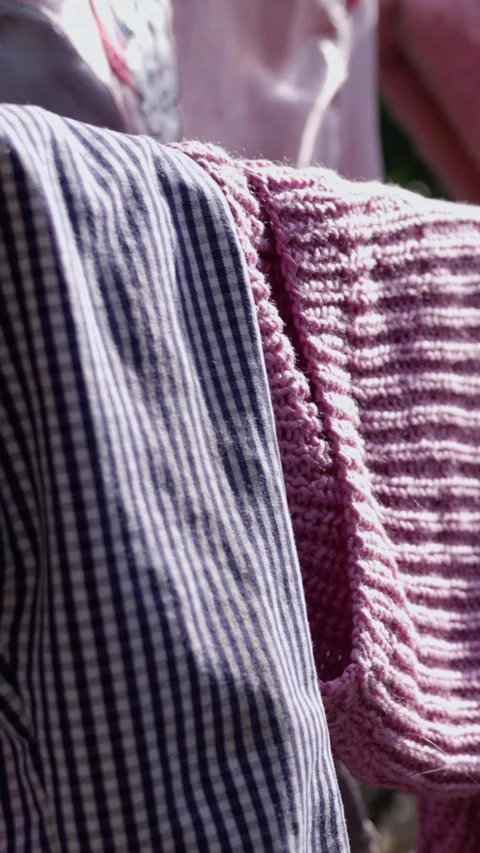 Home work. Washed casual clothes and different linen, hanging on a clothesline Stock Footage 311320301