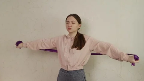 Home Workout Concept Featuring Woman Using Resistance Band for Fitness Traini Stock Footage 307757553