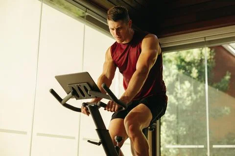 Home workout routine with a high-tech exercise bike Fotos Stock