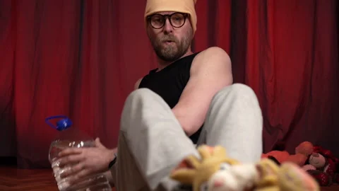 Home Workout.Man performs abs exercise using a bottle of water as a weight. Stock Footage 131095579