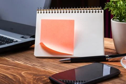 Home workplace with computer, blank notepad, copy space close up Stock Photos