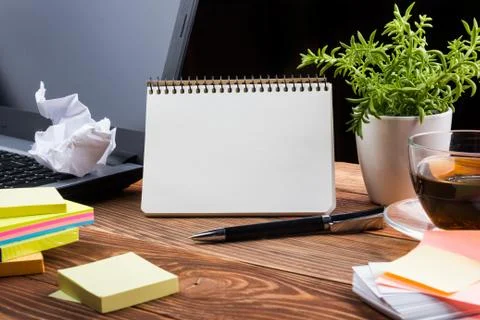 Home workplace with computer, blank notepad, copy space close up Foto stock