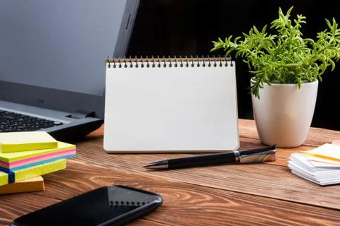 Home workplace with computer, blank notepad, copy space close up Foto stock