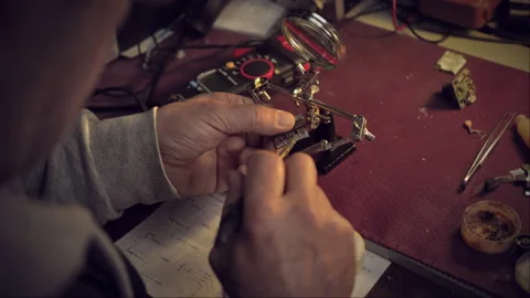 Home workshop. Soldering a circuit using a solder clamp. shallow depth of field Stock Footage 229784179