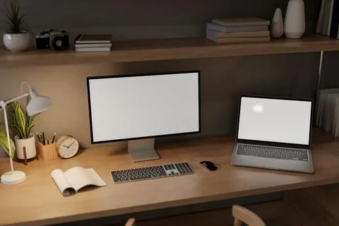 A home workspace at night features a computer and a laptop mockups on a woo.. 스톡 일러스트