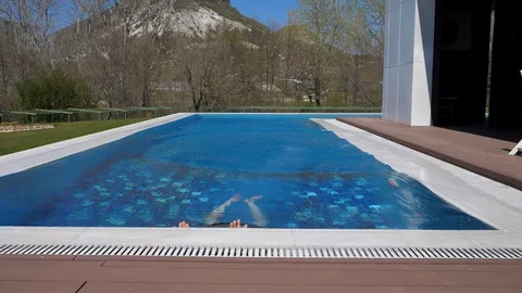 At home.Bald middle-aged man getting out of the pool. Shedding water and puffing 스톡 동영상 129554391