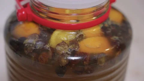 Homebrew Orange Mead Wine, Bubbles in Fermentation Stage Stock Footage 150339653