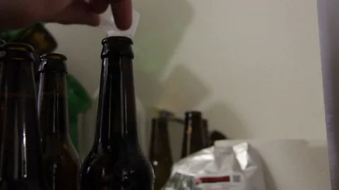 Homebrewing, tap the bottles Stock Footage 76347053