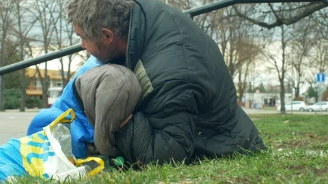 Homeless authentic man sleep in sleeping bag on street wake up Stock Footage 104893745