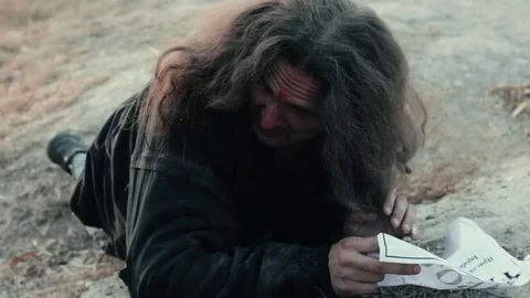 A homeless beggar found the paper document (chance) near the river Stock Footage 75836557
