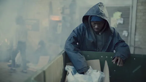 Homeless Black Man Digging through Dumpster in Urban Alleyway Stock Footage 313644713