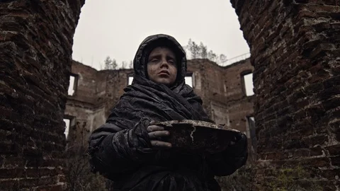 Homeless boy carries water in a bowl on the ruins. War. Apocalypse. Catastrophe. Stock Footage 121874166