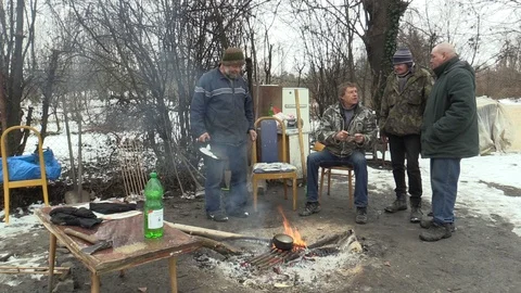 Homeless burning and creating fire to warm themselves in winter, cooking food Stock Footage 86166850
