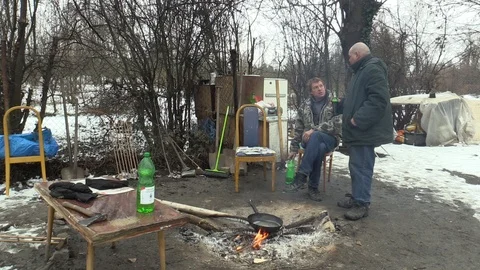 Homeless burning and creating fire in winter, alcohol drinks beer and wine Stock Footage 86195733