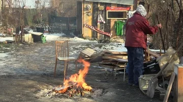 Homeless burning board and creating fire to warm themselves in winter authentic Stock Footage 85834775