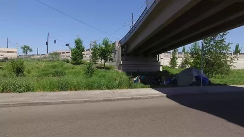 Homeless Camp with Tent Under a Bridge Stock Footage