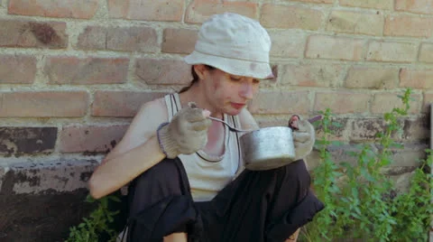 Homeless child eats macaronis Stock Footage 26638022