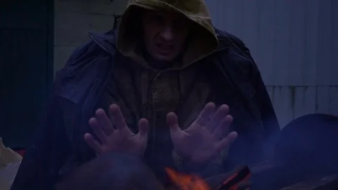 Homeless in front of a fire, close up Stock Footage 82682925