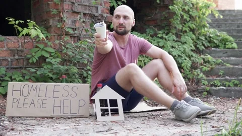 A homeless man asks for help to donate money for food. Stock Footage 304032672