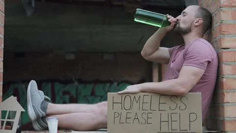 A homeless man asks for help donating money for food. Depressed alcoholic man. Stock Footage 304032679
