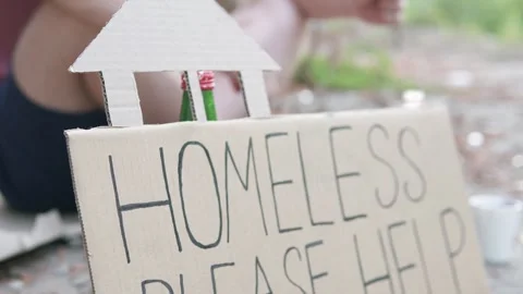A homeless man asks for help in the form of alms. A tramp dreams of a home. Stock Footage 304409930