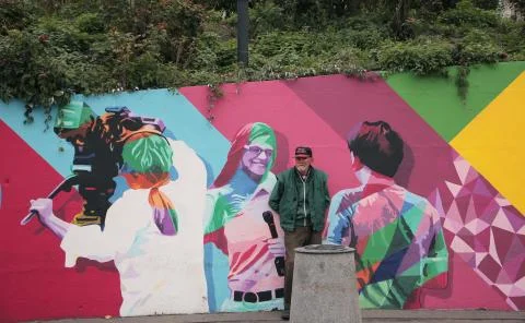 Homeless man on a background of graffiti Stock Photos