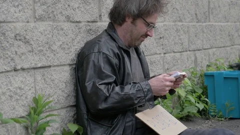 Homeless Man Looking at a Large Stack Of Money Cash Stock Footage 75964512