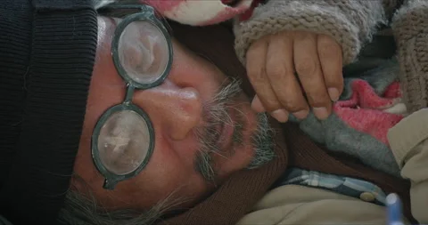 Homeless man is lying down on the sidewalk and asking for money Stock Footage 148004494