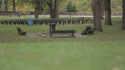 Homeless man on a park bench Stock Footage 87721335