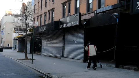 Homeless Man Picking Up Coins on Empty St Marks Streets Coronavirus NYC Video stock 127269882