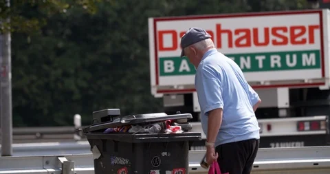 Homeless man searching garbage cans, Germany 4K Stock Footage 114960366