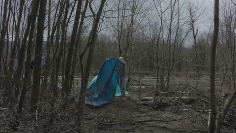 Homeless man setting up a temporary camp in the woods Stock Footage 331659343
