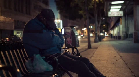 Homeless Man Sleeping on Bench Stock Footage