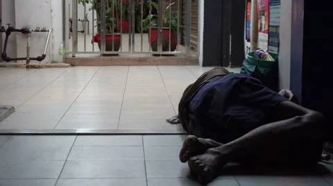 Homeless man sleeping outside on the street Stock Footage