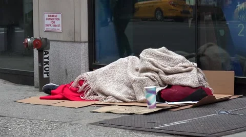 Homeless man sleeps on the NYC street. USA Stock Footage