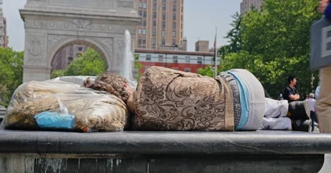 Homeless Man Sleeps in Washington Square Park Stock Footage