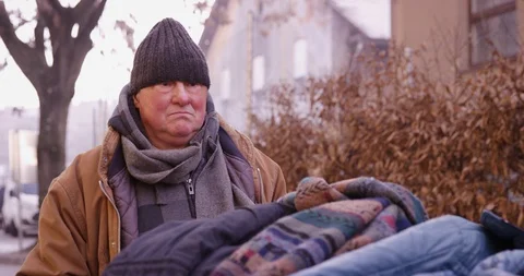 Homeless Man Thinking And Pushing A Cart With Clothes Stock Footage 128774190