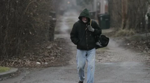 Homeless man walking in an alley Stock Footage