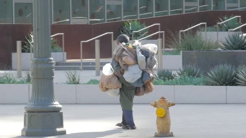 Homeless man walking down the sidewalk  Video stock 82599849